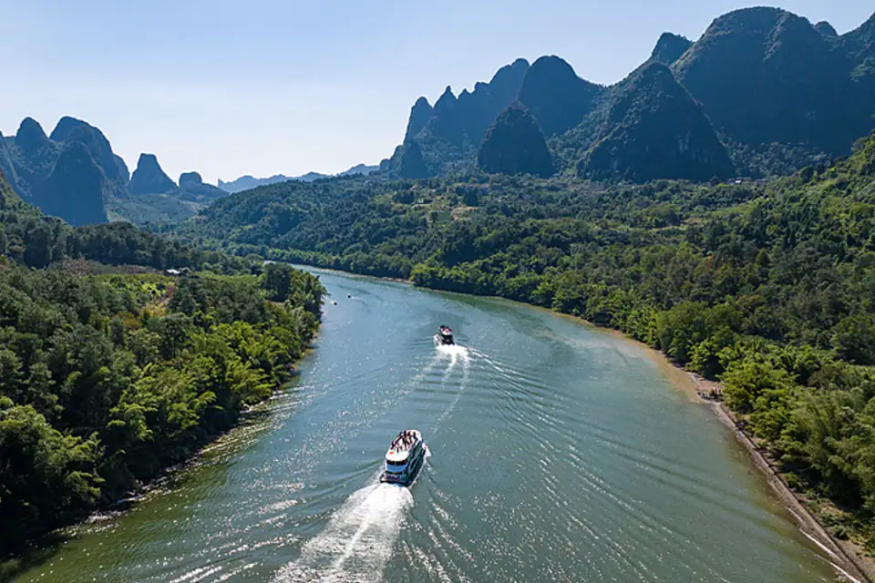 Boats travelling through the karst landscape of Guilin
